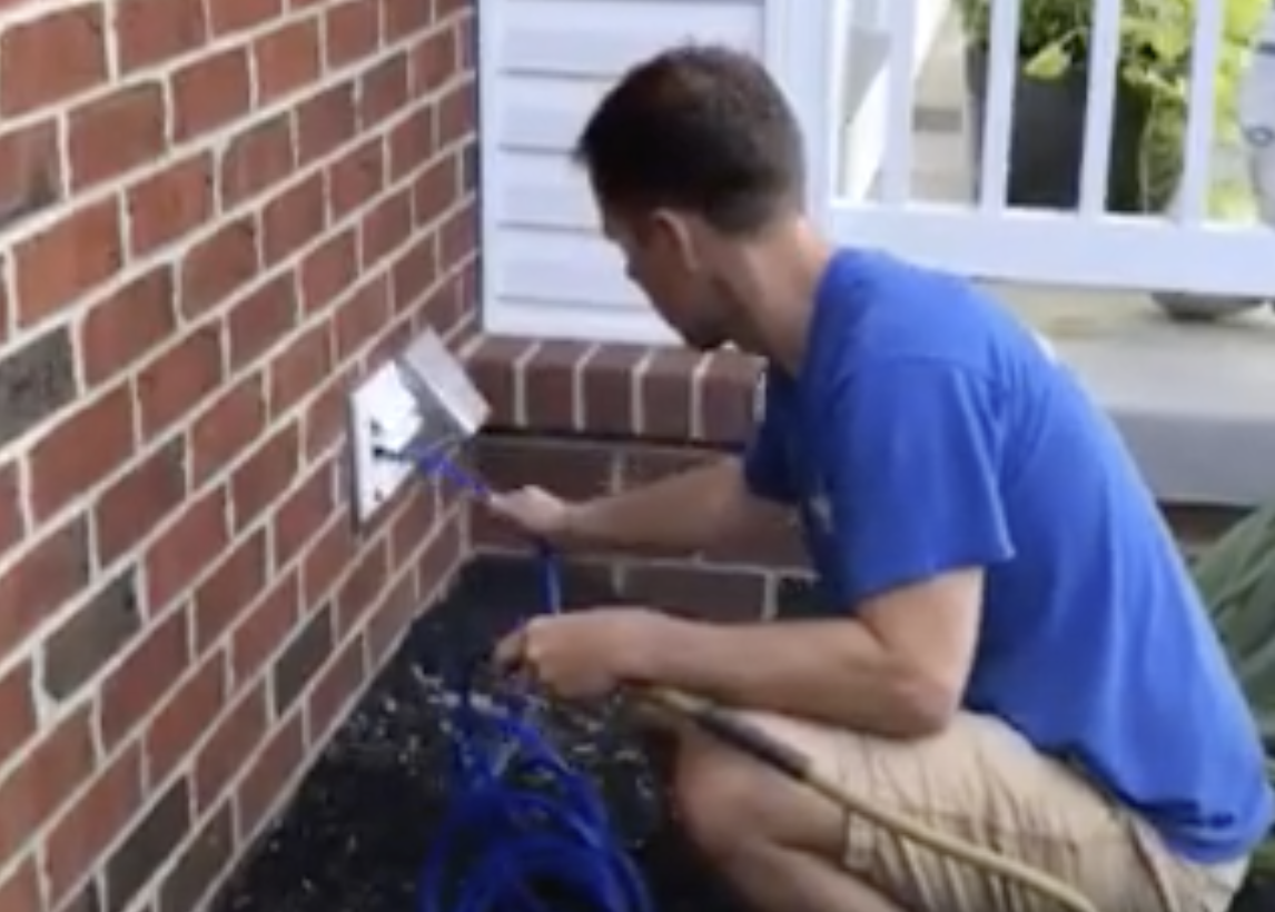 Mobile Works employee cleaning a dryer vent